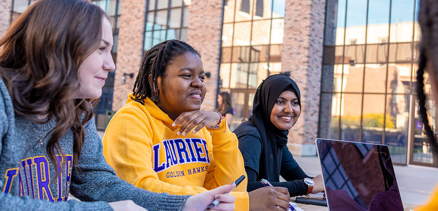 Students outside of RAC building talking. Students outside of RAC building talking.
